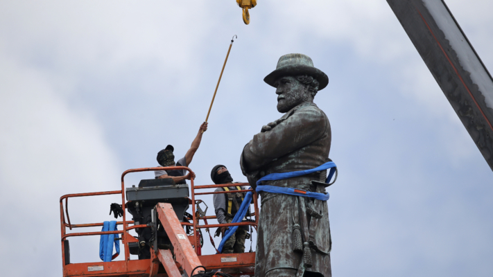 Workers attach a crane to the statue of former Confederate general Robert E. Lee, which stands over 100 feet tall, in Lee Circle in New Orleans, Friday, May 19, 2017. (AP Photo/Gerald Herbert)