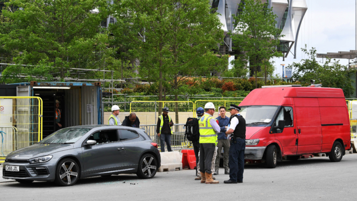 Police stand beside two vehicles in which they carried out controlled explosions near the new but still unoccupied US embassy building in south London, on June 7, 2017. (Justin Tallis/AFP/Getty Images)