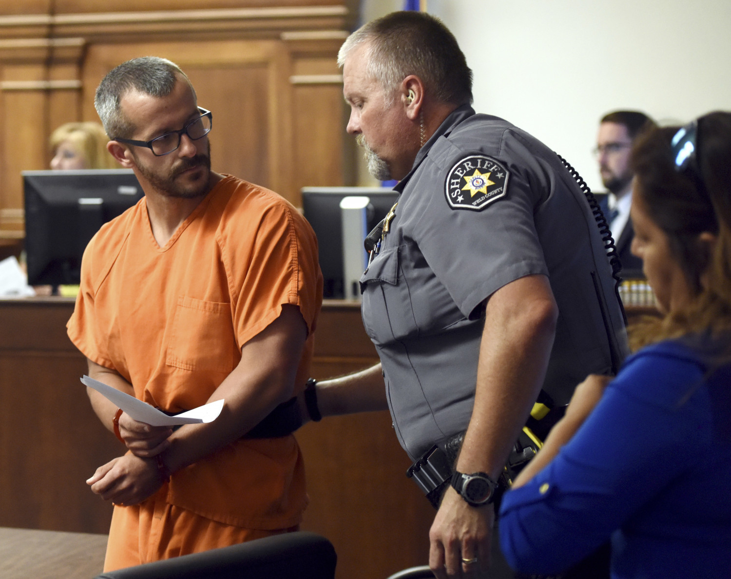 Christopher Watts glances back at a Weld County Sheriff's Deputy as he is escorted out of the courtroom at the Weld County Courthouse Thursday, Aug. 16, 2018, in Greeley, Colorado.