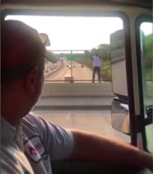 Jason Gabel and Kwame Anderson stand where they convinced a suicidal man not to jump off a highway overpass by offering him cold beer and a few jokes. (Fox screenshot)