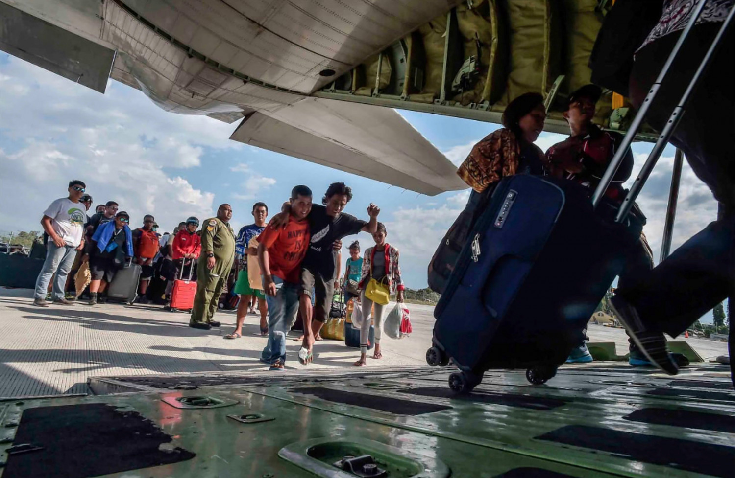 People injured or affected by the earthquake and tsunami are evacuated on an airforce plane in Palu, Central Sulawesi