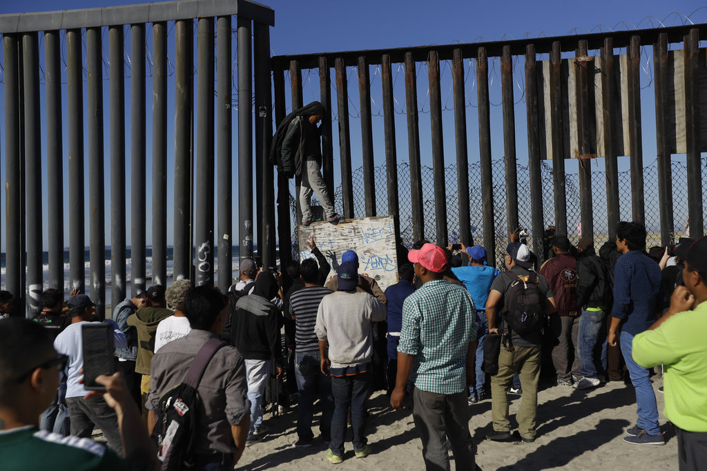 Migrants at Tijuana border fence