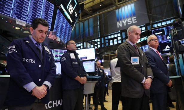 Traders pause for a moment of silence on the floor of the New York Stock Exchange (NYSE) in remembrance of former President George H.W. Bush.