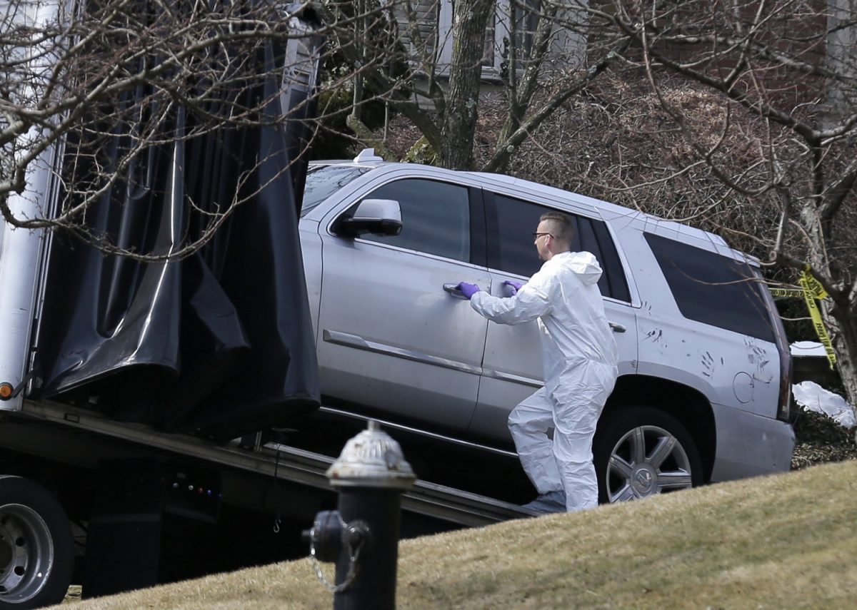 Crime scene investigators load a car that appears to have been checked for ...