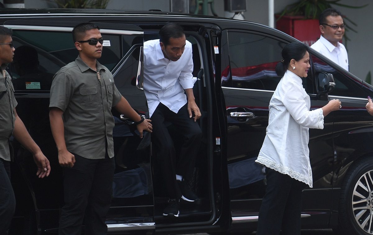 Indonesian President Joko Widodo and first lady Iriana Joko Widodo arrive to cast their ballots