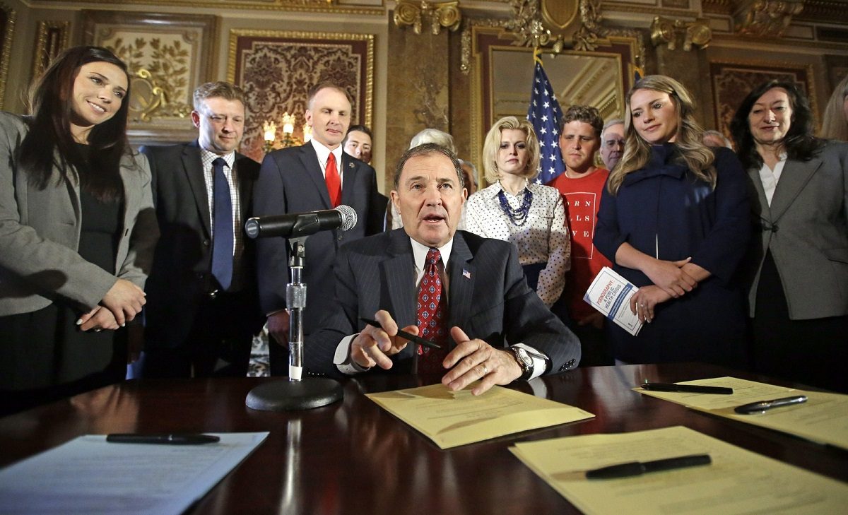 Utah Gov. Gary Herbert looks up during a ceremonial signing of a state resolution