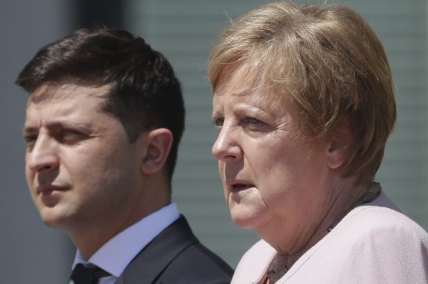 German Chancellor Angela Merkel welcomes Ukraine's President Volodymyr Zelenskiy with military honors for a meeting