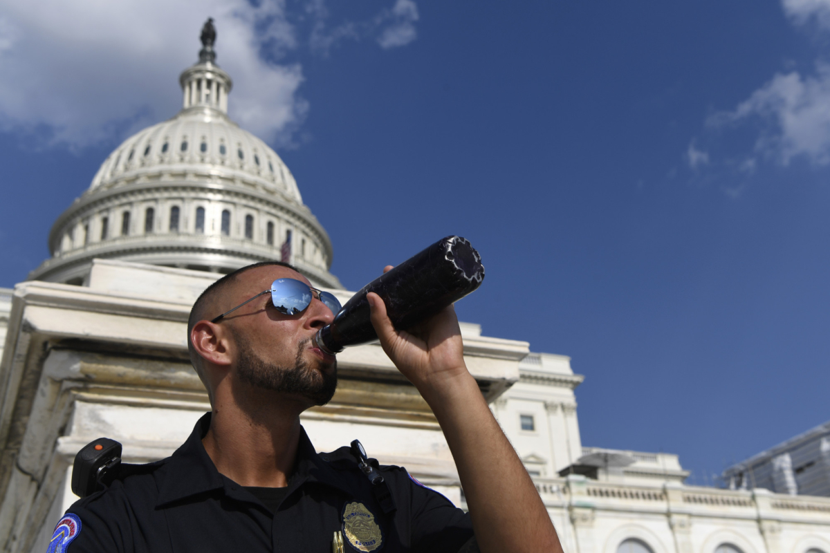 A Capitol Hill police officer takes a drink