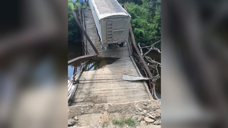 Pictured 100YearOld Bridge Collapses Under Semitruck Nearly Four