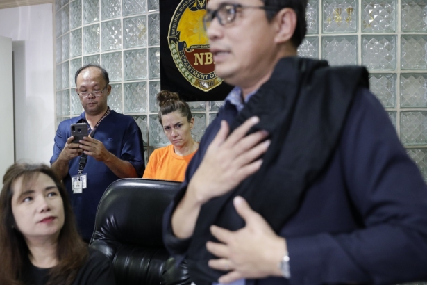 American Jennifer Erin Talbot, center rear, from Ohio looks as National Bureau of Investigation - International Airport Investigation Division chief