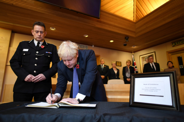 Boris Johnson signs a book of condolence