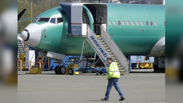 Worker walks past a Boeing 737