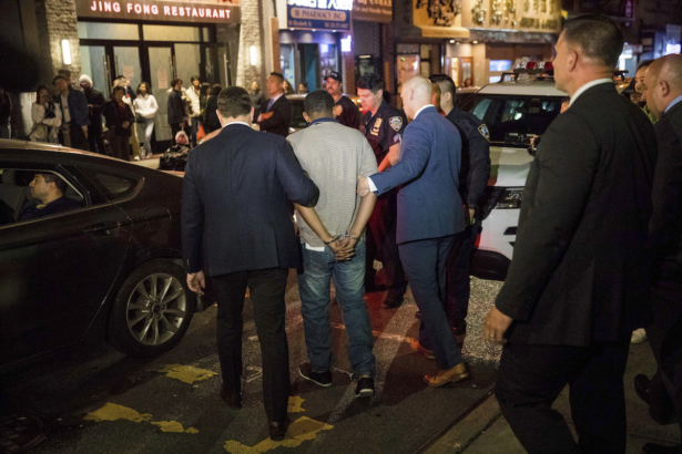 Police officers escort Randy Rodriguez Santos