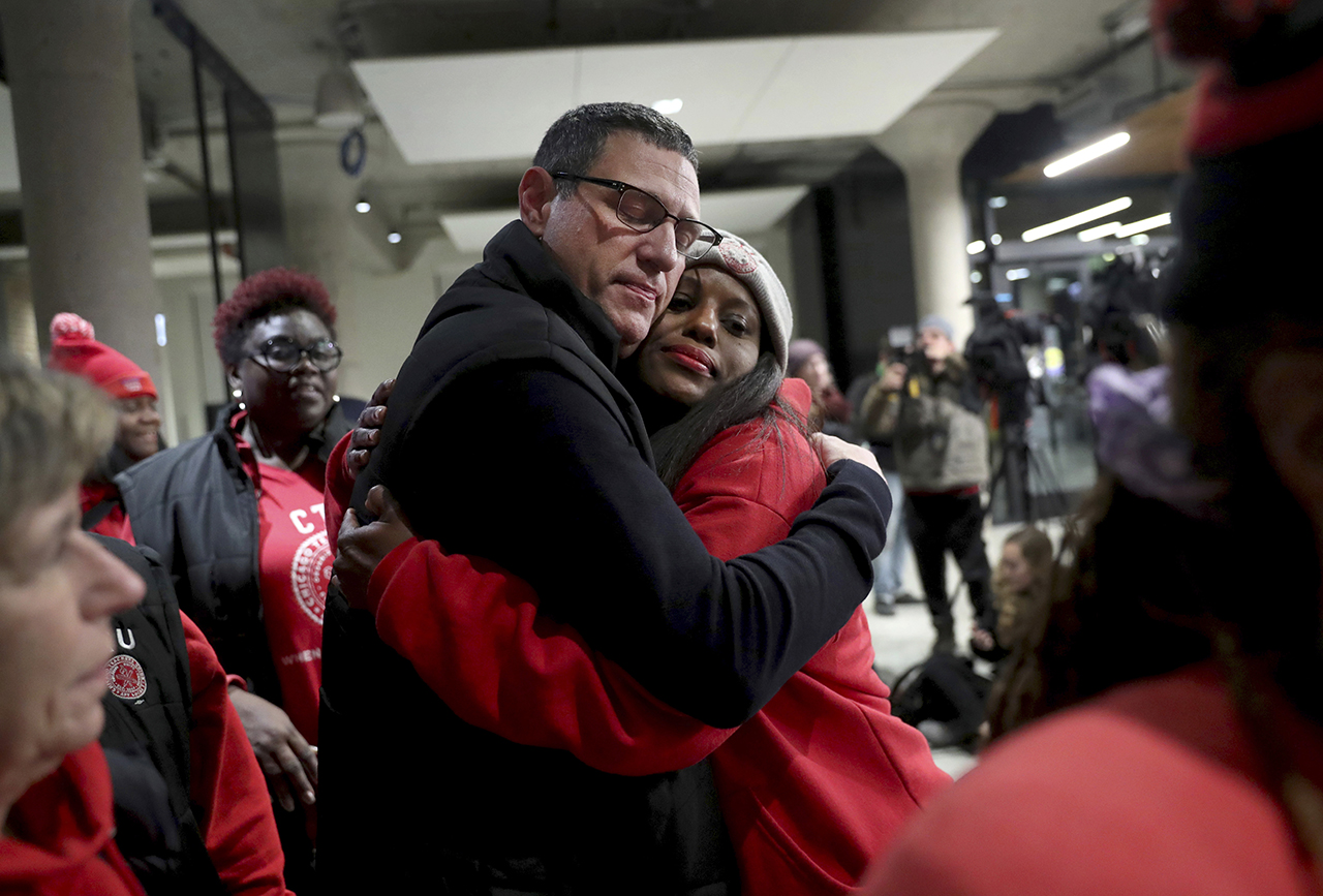 Chicago Teachers Union President Jesse Sharkey and vice-president Stacy Davis Gates share a hug