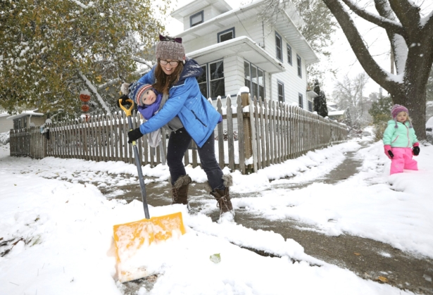 Stephanie Rytilahti shovels the sidewalk