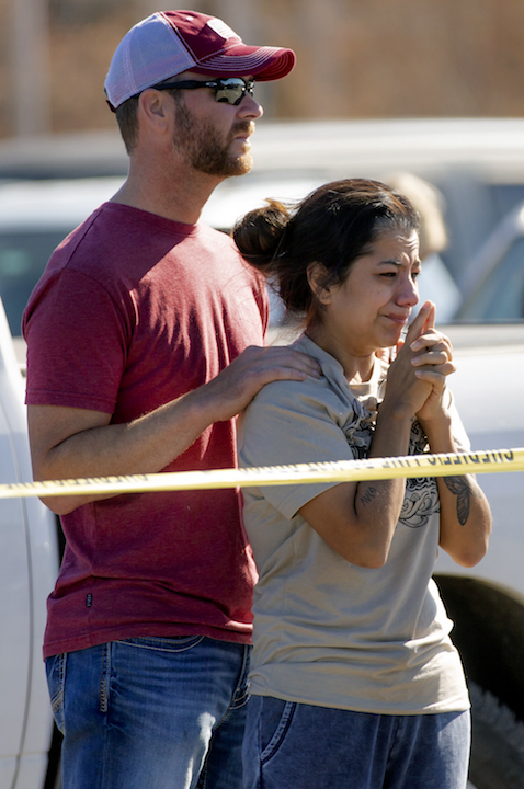 Family members reacts at the scene of a shooting 