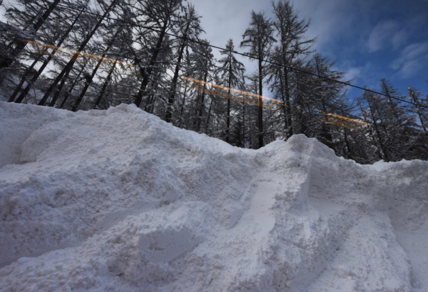 The Zermatt to Tasch train passes by the scene of an avalanche