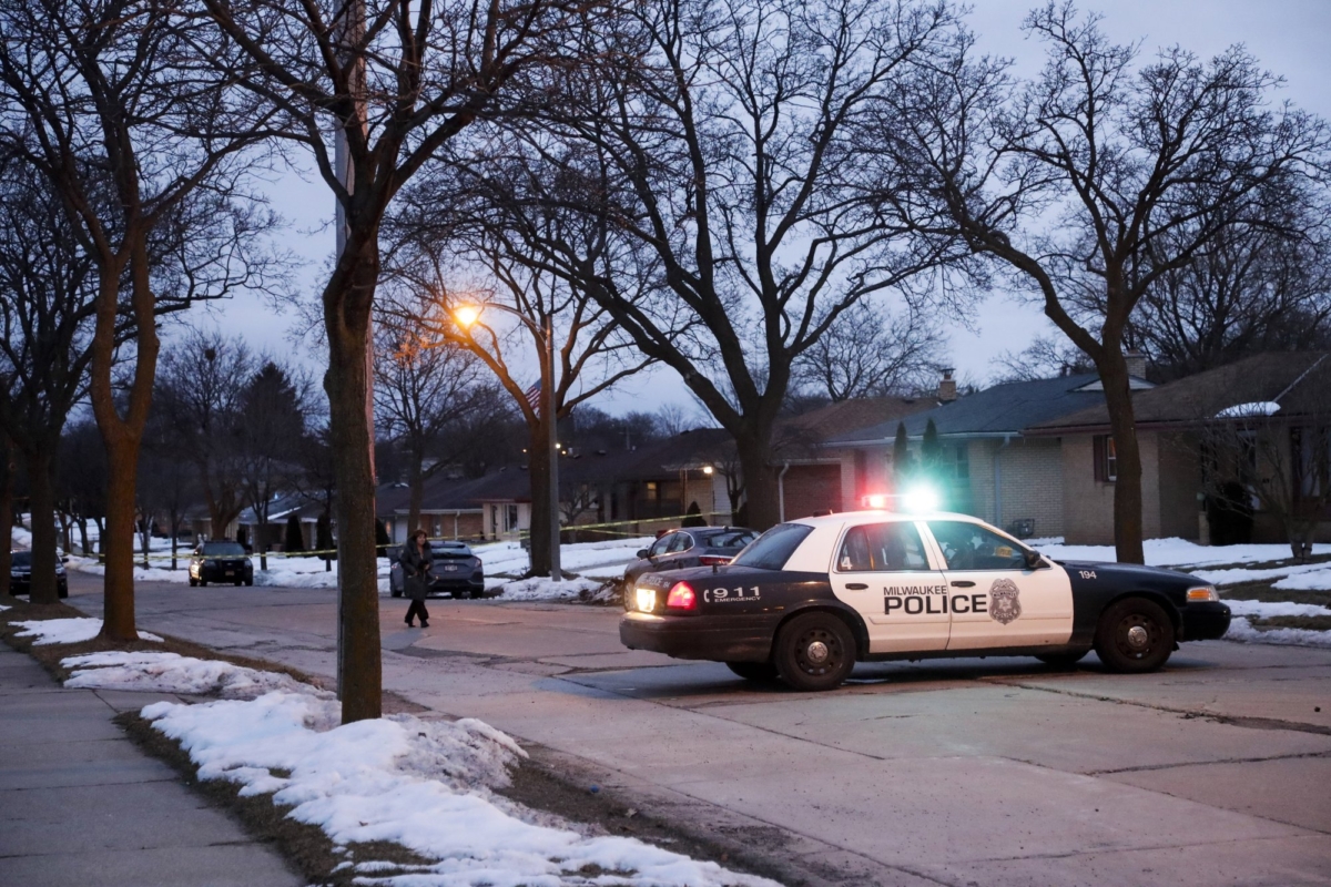 Police are seen outside of a house