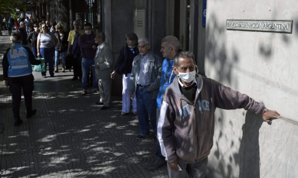 Pensioners queue outside a bank
