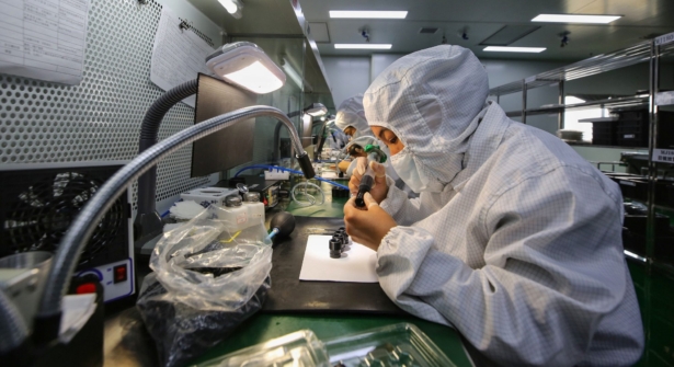 Employees working at a photoelectric production line