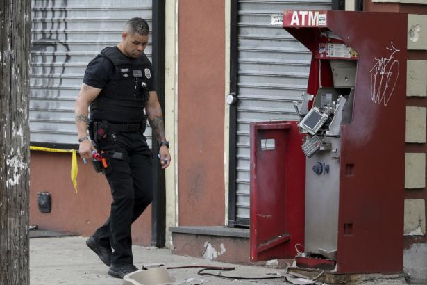 A member of the Philadelphia bomb squad surveys the scene