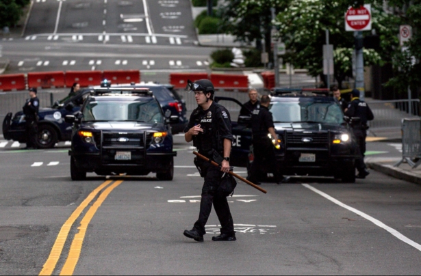 A police officer walks outside of the Seattle Police Departments West Precinct