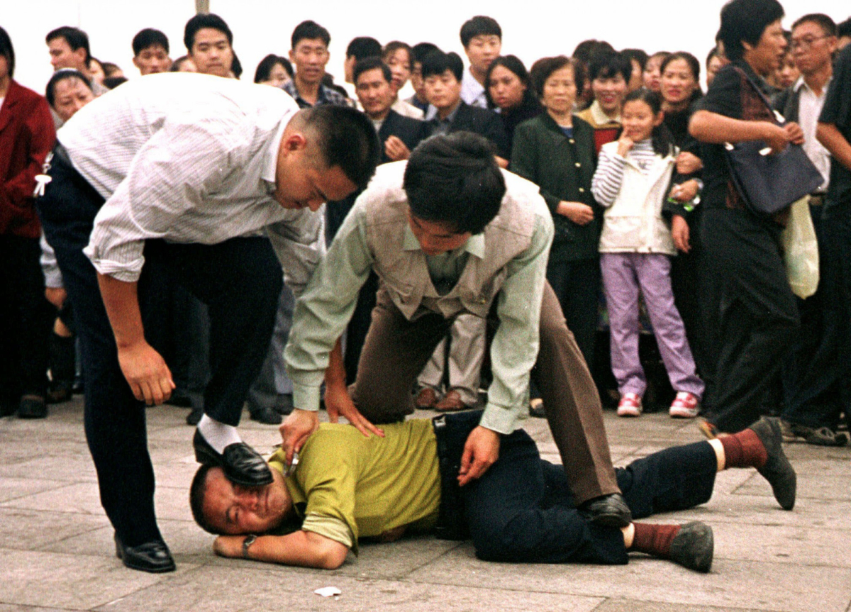 Police detain a Falun Gong protester