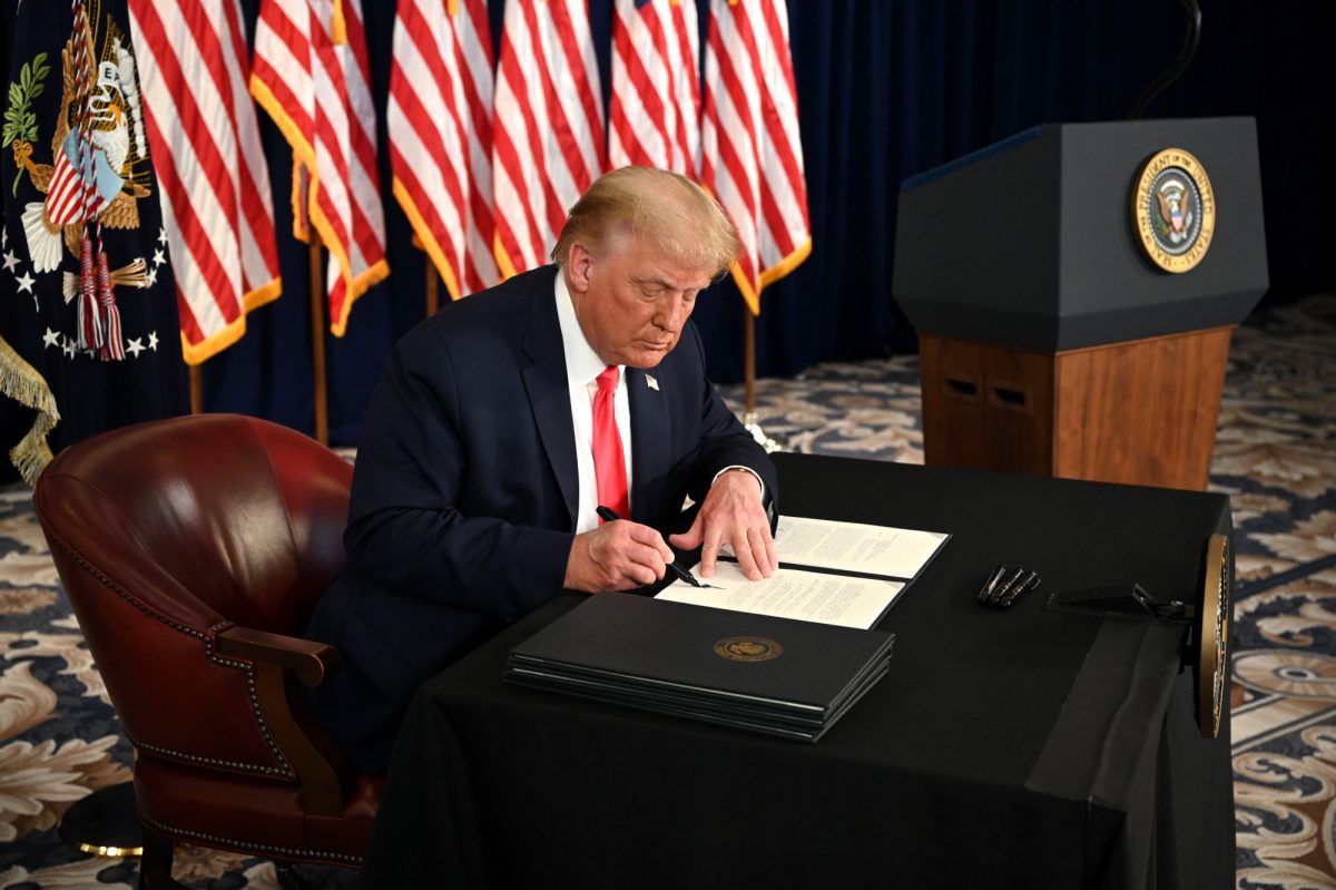 Trump smiles while signing order