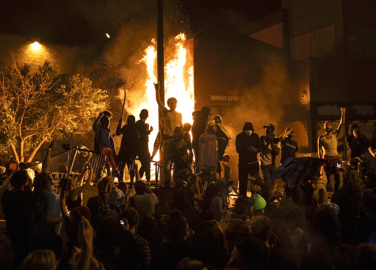 Rioters cheer as the Third Police Precinct