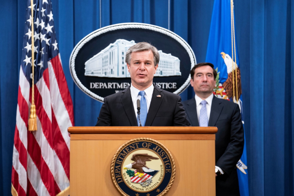 FBI Director Christopher Wray attends a virtual news conference at the Department of Justice in Washington