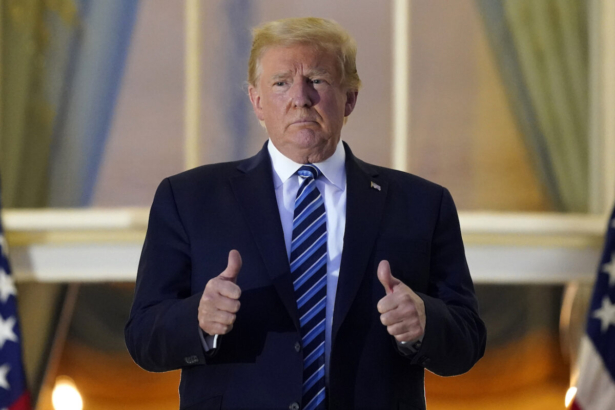 Donald Trump stands on the balcony
