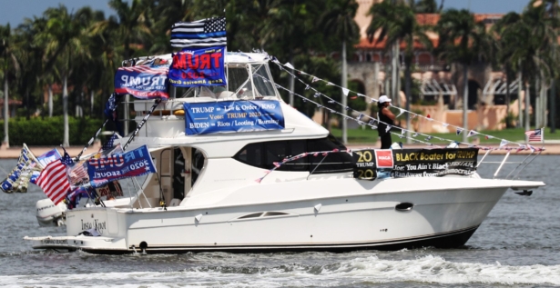 A boat sails with a banner reading ' Black Boater for Trump'