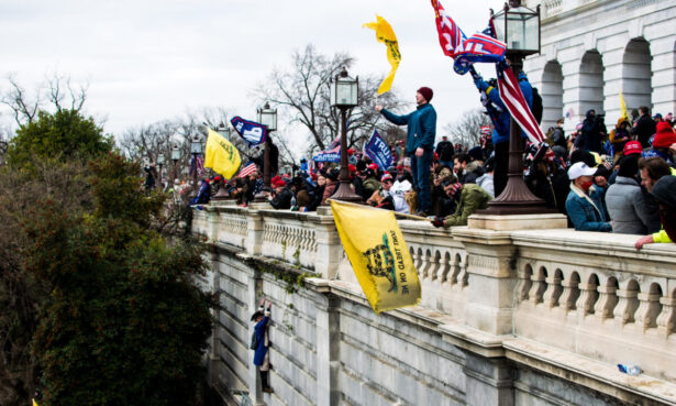 Protesters stand on the veranda