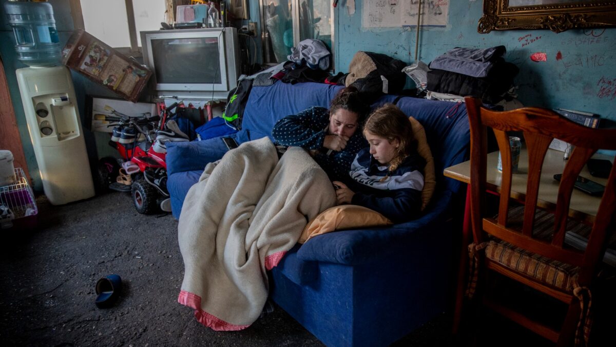A woman rests with her daughter