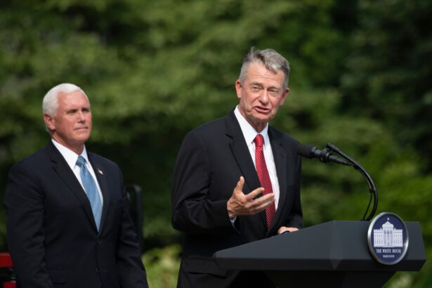 Vice President President Mike Pence (L) listens as Idaho Governor Brad Little