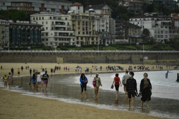 People walk along La Concha beac