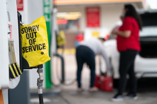 An out of service bag covers a pump handle at a gas station