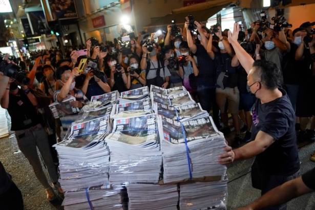 A man gestures as he brings copies