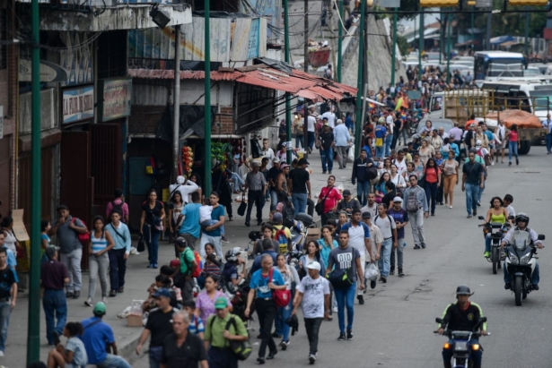 People walk back home in the Petare neighborhood