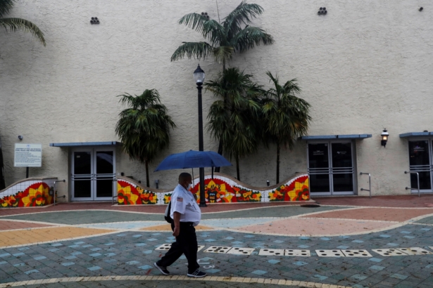 A man walks with an umbrella