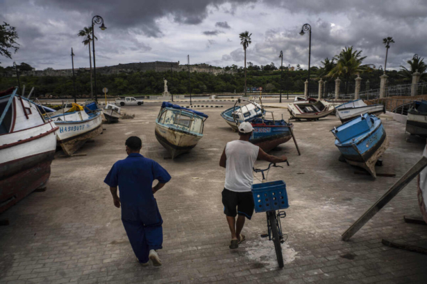 Fishermen inspect their boats