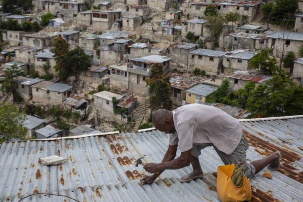 man-secures-roof-of-his-house