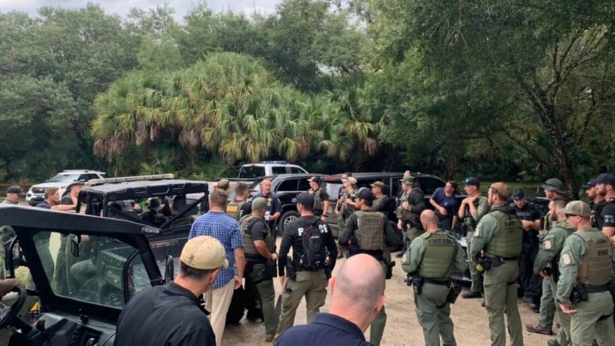 Law enforcement officials conduct a search