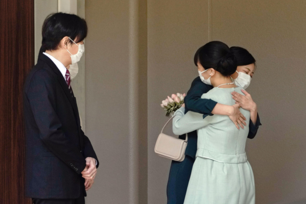 Japan's Princess Mako, right, hugs her sister Princess Kako