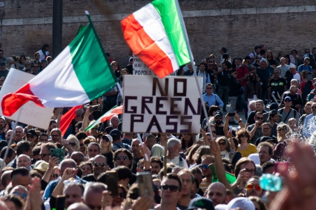 People wave national flags during a protest against the mandatory “green pass” in Rome, Italy on Oct. 9, 2021. (TIZIANA FABI/AFP via Getty Images)