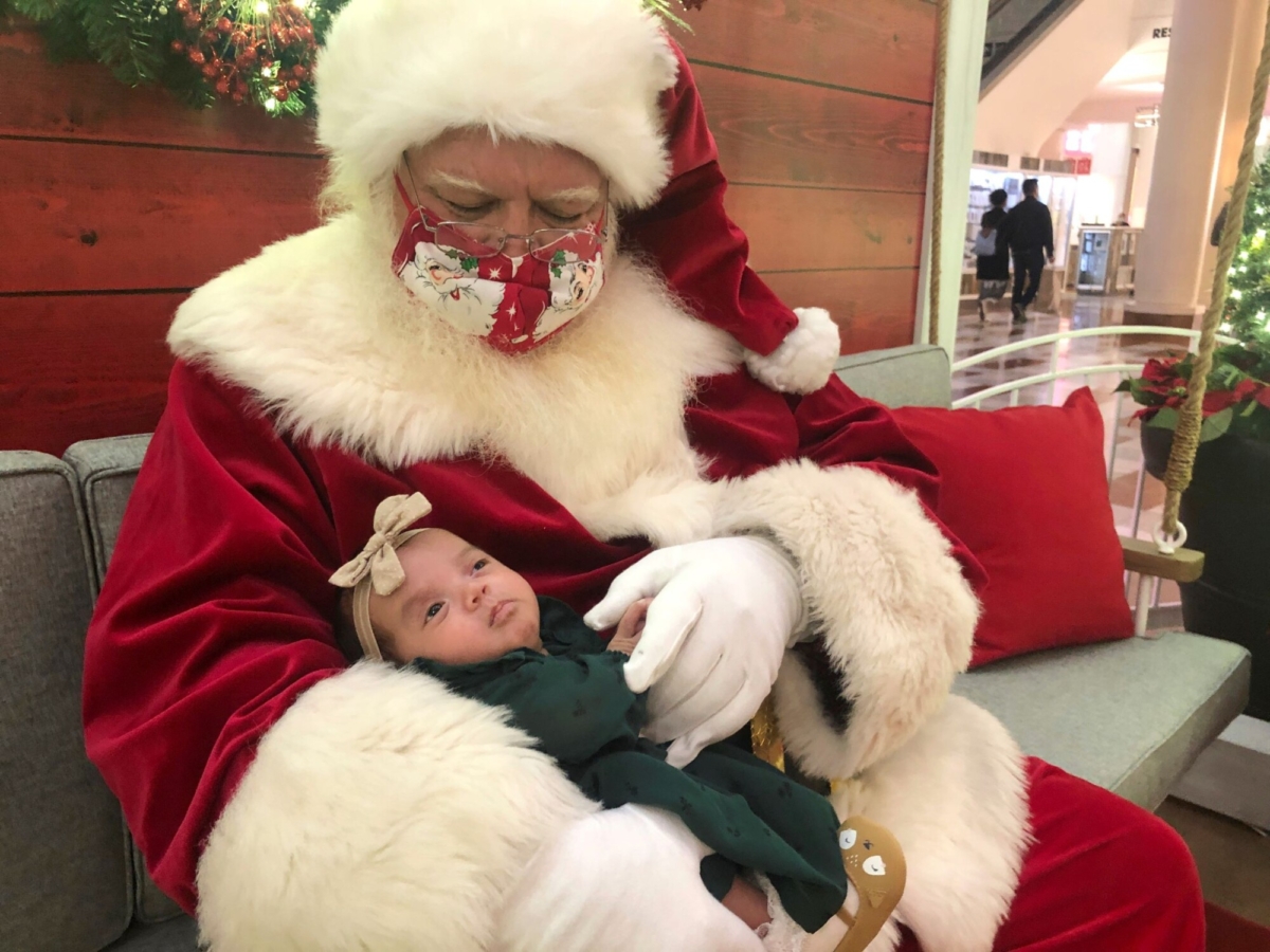 A Santa holds a baby