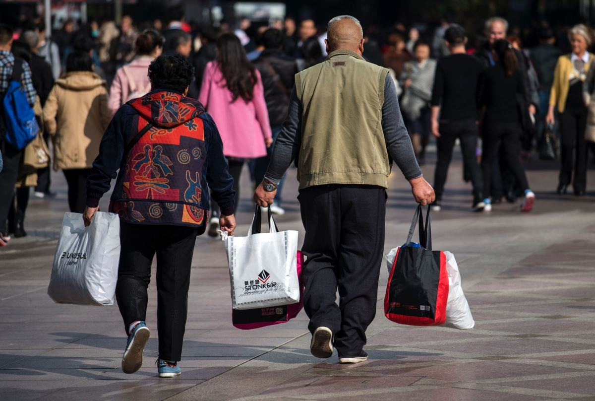 A couple carries shopping bags