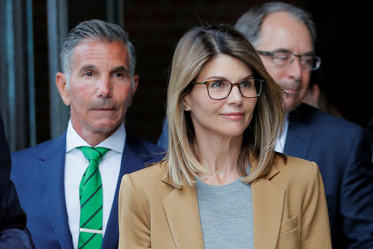 Actor Lori Loughlin, and her husband, fashion designer Mossimo Giannulli, leave the federal courthouse after facing charges in a nationwide college admissions cheating scheme, in Boston