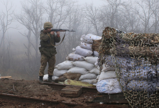 A Ukrainian soldier takes position on the front line at the town of Novoluhanske in the Donetsk region, Ukraine, Monday, Dec. 9, 2019. (Vitali Komar/ AP Photo)