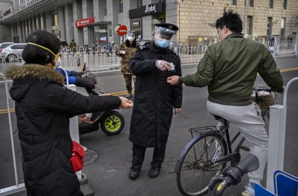 A Chinese security guard wears a protective mask